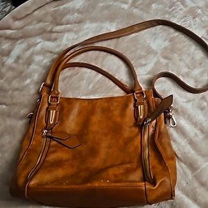 This is a leather tote/satchel. It is huge, very well constructed, holds a ton.